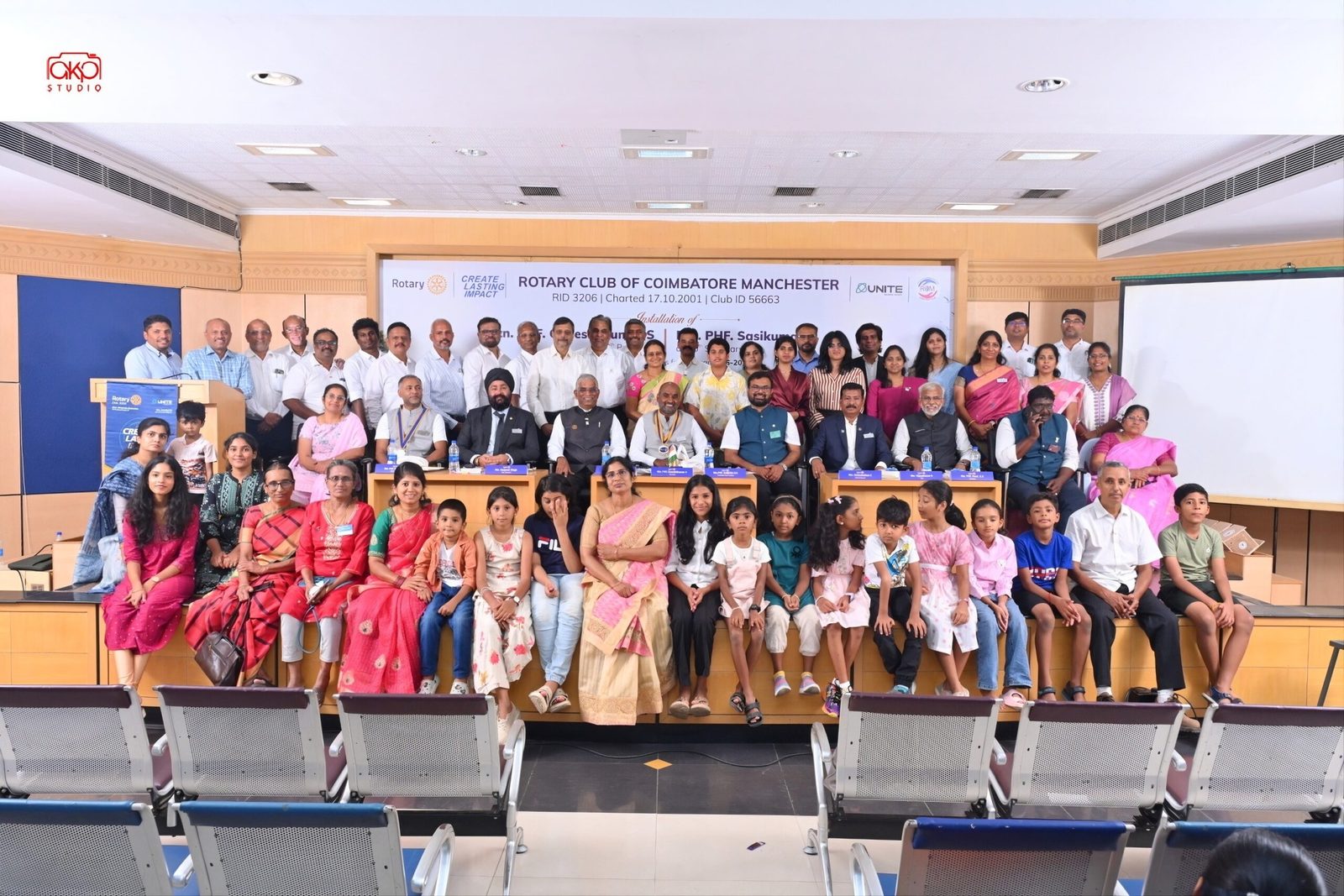 Members of Rotary Club of Coimbatore Manchester with children at a club installation