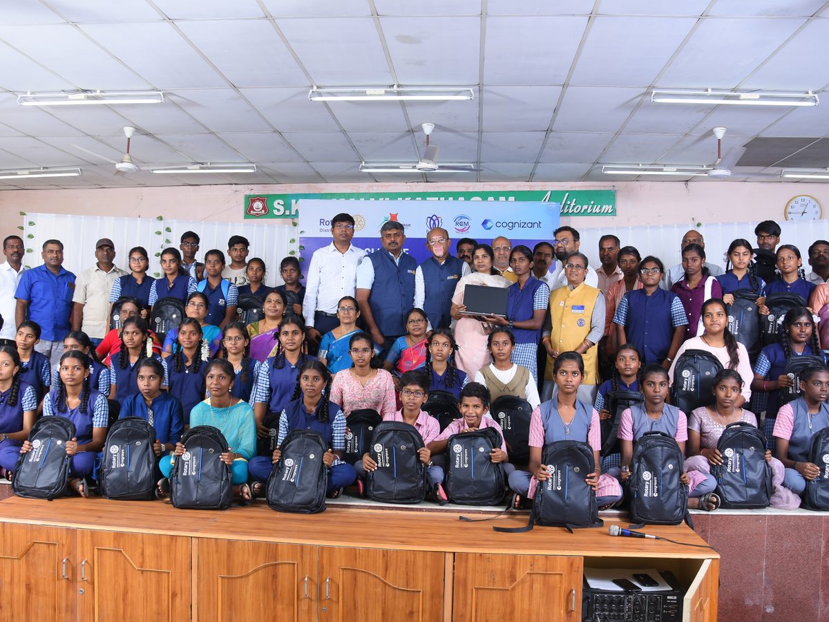 Students receiving backpacks and laptops from Rotary Coimbatore Manchester